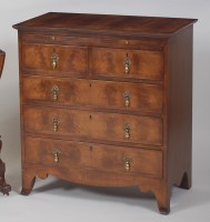 Lot 998 - A figured and crossbanded walnut chest, in the...