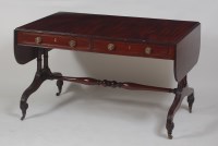 Lot 1013 - A late Georgian mahogany sofa table, the fall...