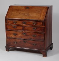 Lot 947 - A George III mahogany slopefront writing...