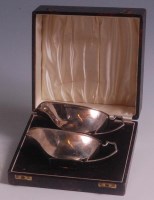 Lot 105 - A pair of cased Art Deco silver sauceboats,...