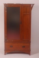 Lot 293 - An Arts & Crafts oak single mirror door...