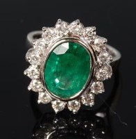 Lot 517 - A contemporary 18ct white gold emerald and...