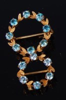 Lot 520 - A 9ct gold blue topaz set wreath brooch, dia.2....