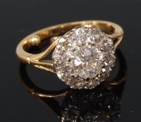 Lot 528 - An 18ct yellow gold diamond cluster ring,...