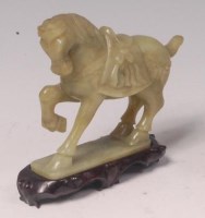 Lot 589 - A Chinese polished and mottled jade carved...