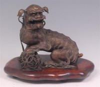 Lot 592 - A Chinese bronze Foo dog, the animated beast...