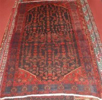 Lot 694 - A Kurdish woollen rug, the midnight ground...