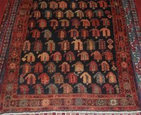 Lot 696 - A Kurdish woollen rug, the field with stylised...