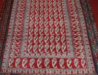 Lot 697 - A Persian woollen Bokhara rug, the red ground...