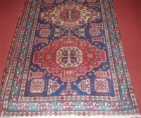 Lot 698 - A Persian woollen rug, the triple medallion...