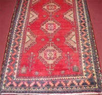 Lot 699 - A Persian woollen rug, having a poled field...