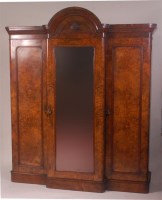 Lot 770 - A Victorian figured walnut breakfront triple...