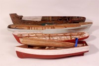 Lot 143 - 4 wooden, 1 brass and 1 plastic boat hulls,...