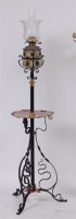 Lot 218 - An Art Nouveau black painted wrought iron and...