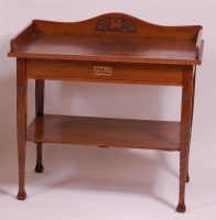 Lot 254 - An Art Nouveau oak two tier side table, having...