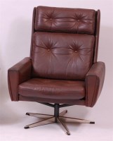 Lot 267 - A 1960s Danish brown leather swivel armchair,...