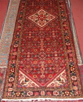 Lot 814 - A Persian woollen runner, having a complex red...