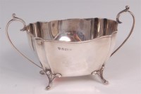 Lot 499 - An Edwardian twin handled sugar, raised on...