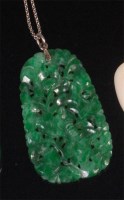 Lot 550 - A 1920s carved spinach jade pendant, of shaped...