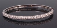 Lot 570 - A Tiffany Metro platinum and diamond hinged...