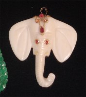 Lot 551 - An Indian carved ivory and ruby set pendant,...