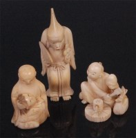 Lot 691 - A Japanese carved ivory miniature Okimono,...