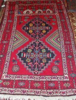 Lot 811 - A Kurdish woollen rug, the red ground with a...