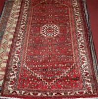 Lot 812 - A Persian woollen Shiraz rug, having a complex...