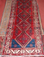 Lot 815 - A Persian woollen runner, the red ground...