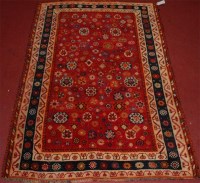 Lot 818 - A Persian Quashqai woollen red ground rug,...