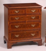 Lot 839 - A figured walnut and crossbanded chest, in the...