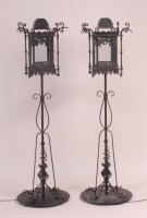 Lot 903 - A pair of wrought iron glazed standard lamps,...