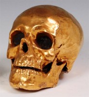 Lot 73 - A gilt ceramic desktop skull, h.14.5cm...