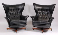 Lot 346 - A pair of 1960s black leatherette wingback and...