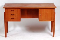 Lot 355 - A Danish 1960s teak kneehole writing desk,...