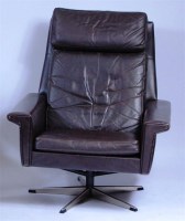 Lot 361 - A 1960s brown leather swivel armchair, raised...