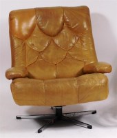 Lot 362 - A 1960s green leather swivel armchair, raised...