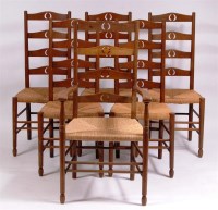 Lot 376 - A set of six Arts & Crafts oak ladderback rush...