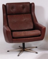 Lot 386 - A Danish 1960s brown leather swivel bucket...