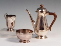 Lot 78 - A late Arts & Crafts silver three piece coffee...