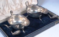 Lot 120 - A cased pair of silver sauceboats with ladles,...