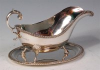 Lot 159 - A George V silver sauceboat on stand, having a...