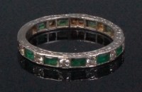 Lot 178 - A white metal emerald and diamond set eternity...