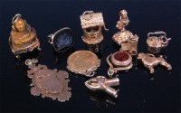 Lot 187 - A collection of gold charms, to include;...