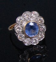 Lot 210 - A ladies 18ct gold sapphire and diamond flower...