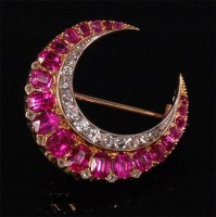 Lot 244 - A yellow gold ruby and diamond set crescent...
