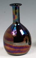 Lot 89 - A mid 20th century dark opaque glass bottle...