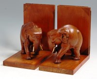 Lot 213 - A pair of teak elephant bookends, each in...