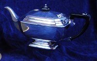 Lot 239 - An Art Deco style silver teapot, having hinged...