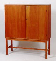 Lot 366 - A 1970s teak double door side cupboard, having...